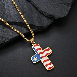 Detailed close-up of gold stainless steel cross necklace with American flag enamel art