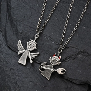 Retro angel and devil pendants in vintage silver steel finish on a dark stone background