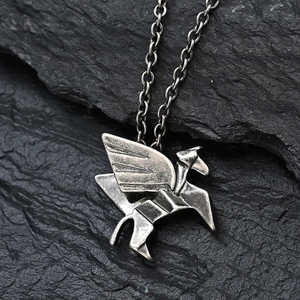 Macro shot of origami Pegasus pendant with geometric wings and antique metal finish