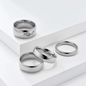 Detailed view of silver stainless steel ring set with hollow heart and polished bands