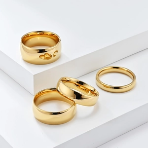 Polished gold plated titanium steel rings set featuring a heart cut-out detail on white blocks