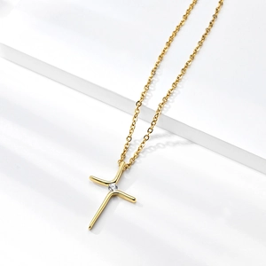 Minimalist gold plated stainless steel cross necklace with a sparkling cubic zirconia stone