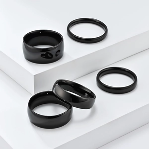 Set of five minimalist black polished stainless steel rings for stacking and versatile wear