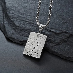 Gothic punk skull pendant necklace in silver stainless steel on dark rock background