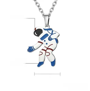 Macro detail of polished stainless steel astronaut pendant showing blue enamel finish
