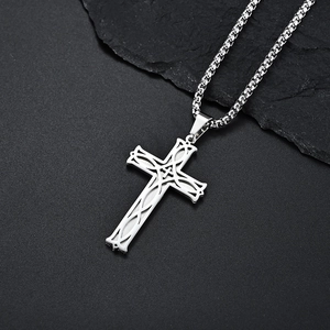 Minimalist stainless steel Celtic cross pendant with box chain on dark textured stone