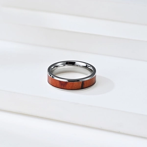 Polished stainless steel ring with natural wood inlay for men and women on white stand