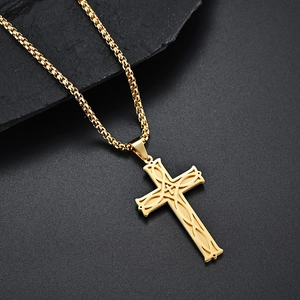 Detailed close-up of golden Celtic cross pendant featuring intricate knotwork on dark stone