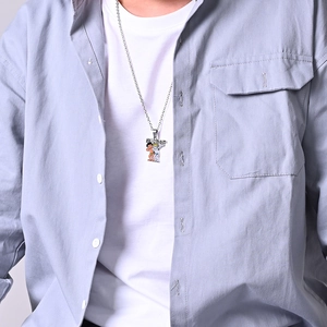 Close-up of street pop style necklace with colorful Higher cartoon pendant on white t-shirt