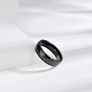 Minimalist black ceramic faceted geometric ring with reflective diamond cut surfaces