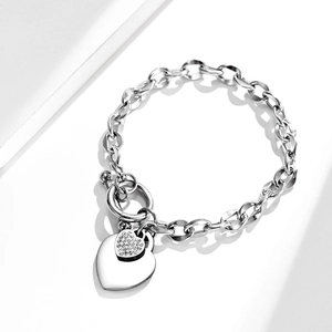 Silver heart pendant bracelet with OT toggle clasp and crystal details on white backdrop