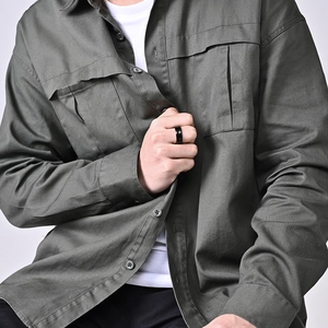 Minimalist matte black stainless steel ring worn on model for a modern unisex look