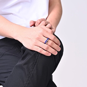 Minimalist silver and blue double ring on hand, stylish stacked stainless steel design
