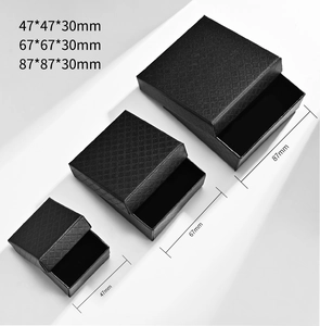 Three black textured jewelry boxes in various sizes with diamond pattern finish