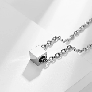 Minimalist stainless steel square cube pendant necklace with O-chain on white background