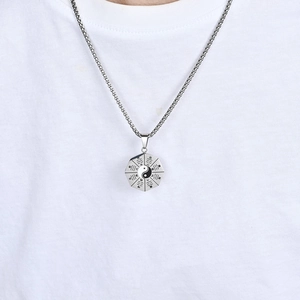 Detail of silver Tai Chi Bagua pendant with octagon Yin Yang design and box chain