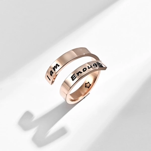Detail of rose gold wrap ring with I am Enough engraving and star symbol inside