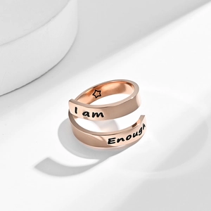Detail view of rose gold spiral ring with I am Enough engraving and inner star mark