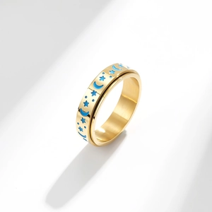 Gold spinner ring with blue star and moon glow patterns on polished stainless steel