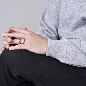 Detailed view of the irregular molten silver ring with a minimalist liquid metal texture