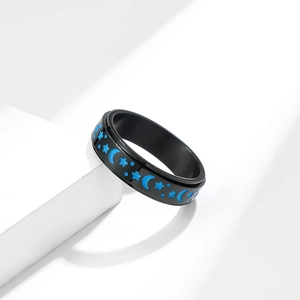 Black stainless steel fidget ring with glowing blue star and moon spinning band