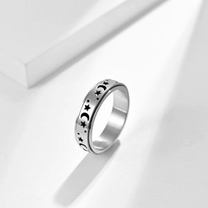 Polished stainless steel spinning ring with celestial star and moon patterns for anxiety relief