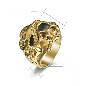 Macro shot of high polished gold steel ring with snake and skull punk gothic relief