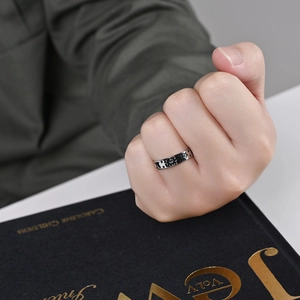Détail d'une bague en acier argenté vintage avec symboles de soleil et d'étoiles