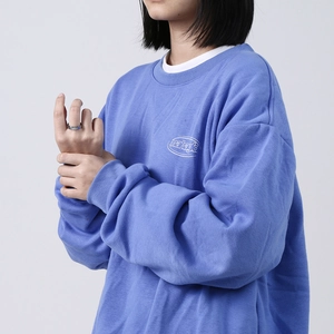 Blue crewneck sweatshirt with white mahagrid logo and silver wide band ring detail