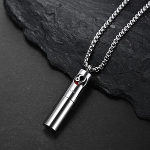Macro del ciondolo zodiaco Leone in argento con nucleo rosso e catena a carrarmato su roccia