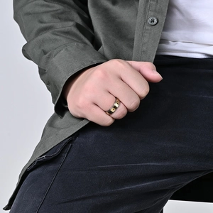 Detailed close-up of a rotating stainless steel ring with gold sun and moon engravings