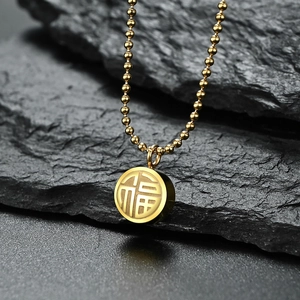 Golden Fu pendant necklace in stainless steel with 18K plating on dark mineral background