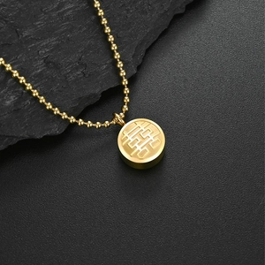 Macro detail of 18K gold plated double-sided Fu Xi character pendant on beaded chain