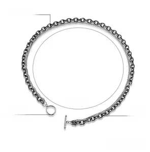 Detail of vintage dual-layer stainless steel necklace with black Cuban chain and OT clasp