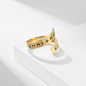Golden Viking Rune stainless steel open ring displayed on a minimalist white stone pedestal