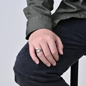 Close-up of vintage Nordic Viking totem engraved stainless steel wrap ring on hand