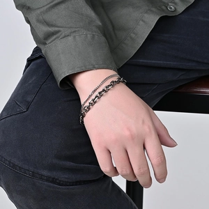 Close-up of double-layer stainless steel bracelet with mixed Cuban and oval chain links