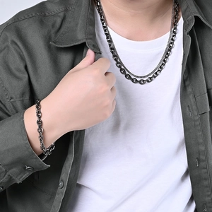 Close-up of vintage industrial double-layered stainless steel chain necklace on a model