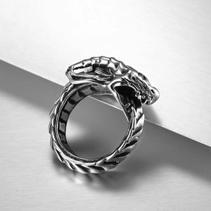 Macro close-up of vintage punk dragon ring with detailed scales and silver textures