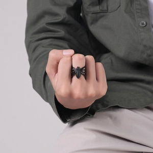 Close-up of a gothic black spider ring with micro-crystals on a model's hand