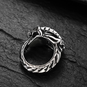 Macro shot of punk style stainless steel ring with detailed dragon scale 3D carving
