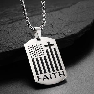 Detailed side view of silver stainless steel dog tag with FAITH and cross engravings