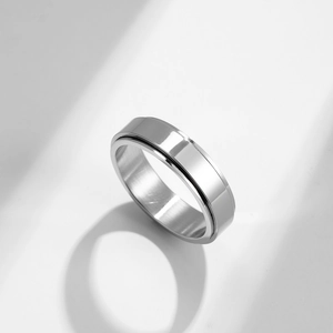 Minimalist silver stainless steel spinner ring with a polished surface and inner texture