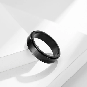 Minimalist black stainless steel spinner ring with a matte finish for men and women