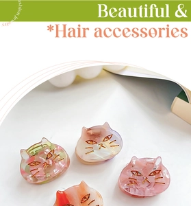 Detailed macro view of acetate cat hair claws in pink, orange, iridescent and cream colors