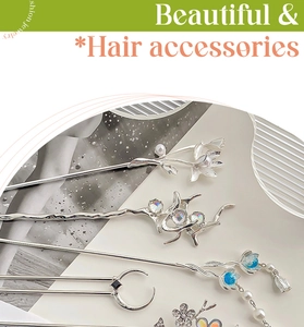 Flat lay of vintage silver hairpins with moonstone, pearls and delicate tassels