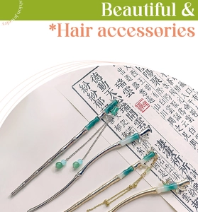 Detail of bamboo joint hair sticks with emerald green beads and metallic tassels