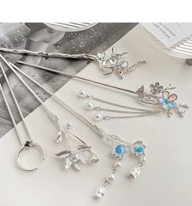 Detailed collection of silver hair sticks with moonstone tassels and floral motifs