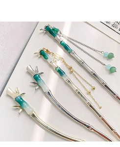 Detailed view of bamboo hair sticks with elegant tassels and jade green gradient finish
