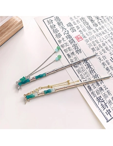 Macro view of Chinese bamboo hairpins with green resin beads and hanging tassels